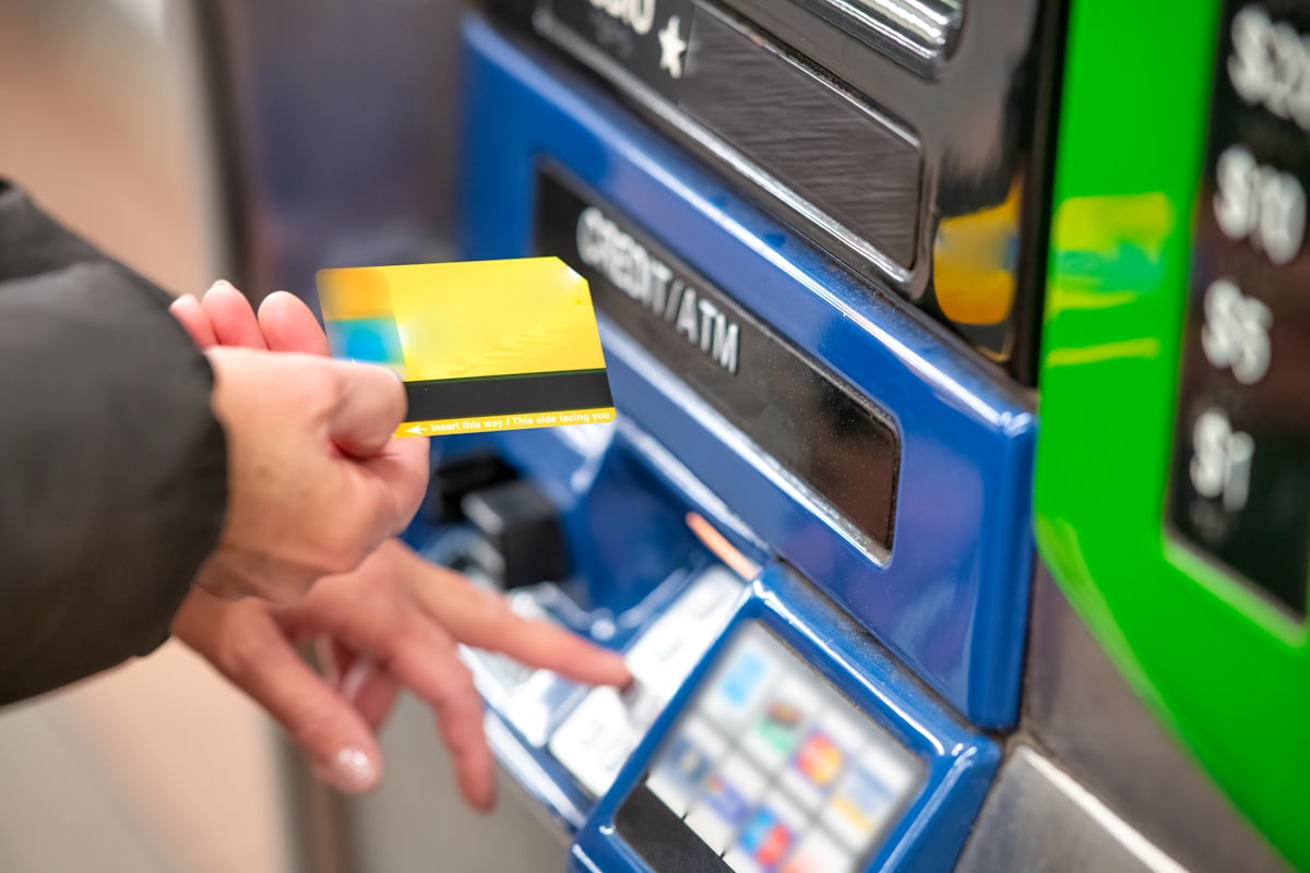 Person using a debit card at an ATM machine
